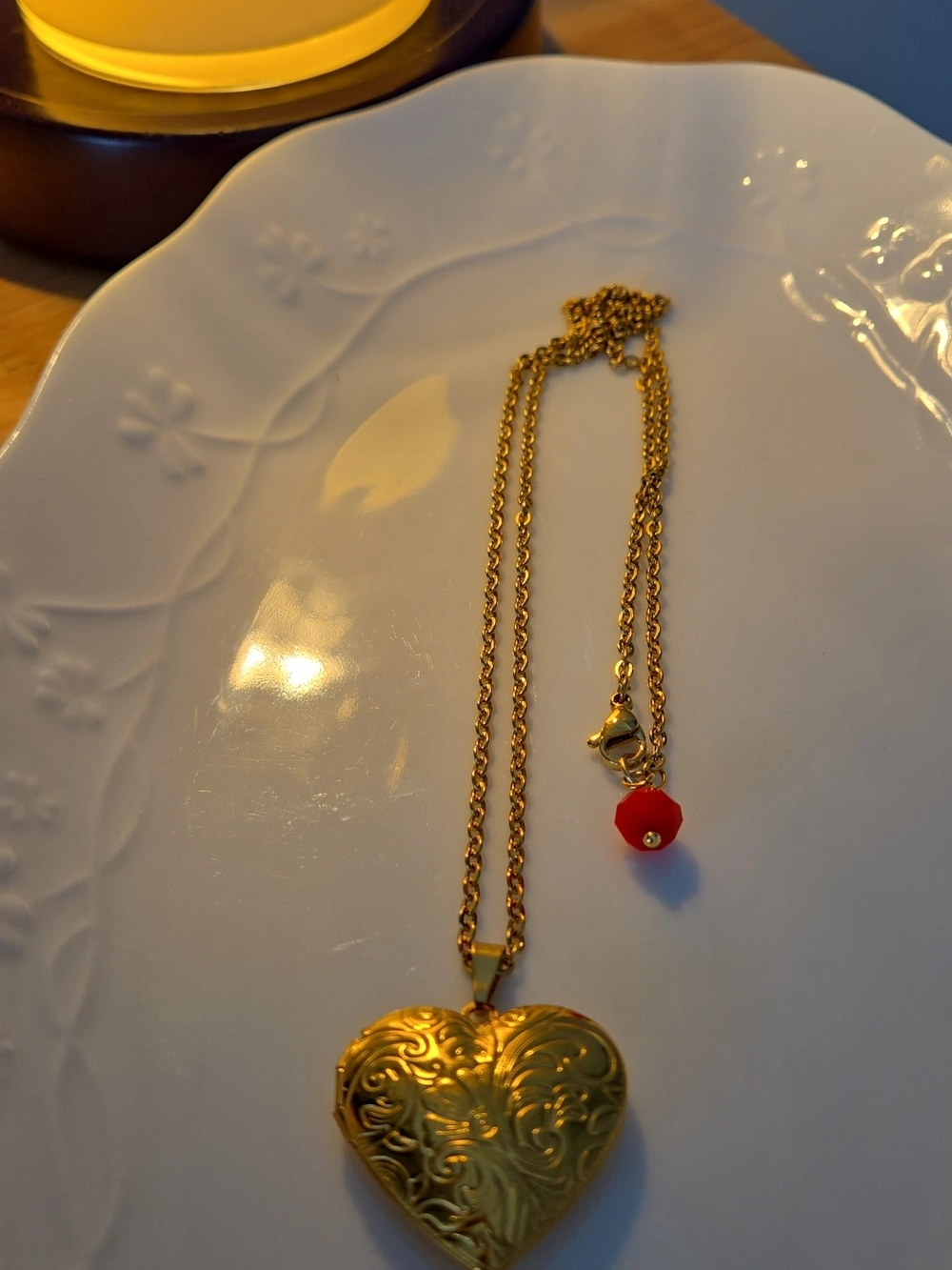 Gold Heart Locket Necklace with Red Accent.